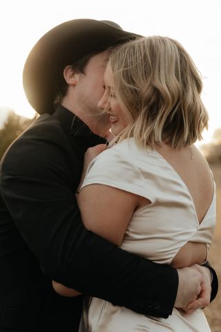 A couple in neutral attire run in an open field take their cinematic and documentary style engagement photos by Hannah Lylene Photography.