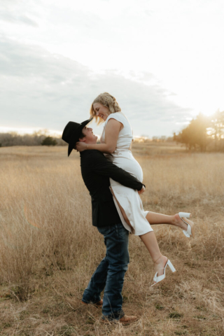 A couple in neutral attire run in an open field take their cinematic and documentary style engagement photos by Hannah Lylene Photography.