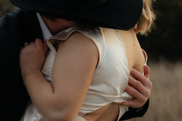 A couple in neutral attire run in an open field take their cinematic and documentary style engagement photos by Hannah Lylene Photography.