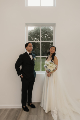 A bride and groom have a candid documentary elopement wedding ceremony in Houston, Texas at the Addison Woods Wedding Venue followed by modern classy bridal portraits and candid photos while interacting with their reception guests.