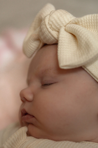 A young couple holds their newborn baby in their nursery to take intimate family photos in Dallas, Texas.