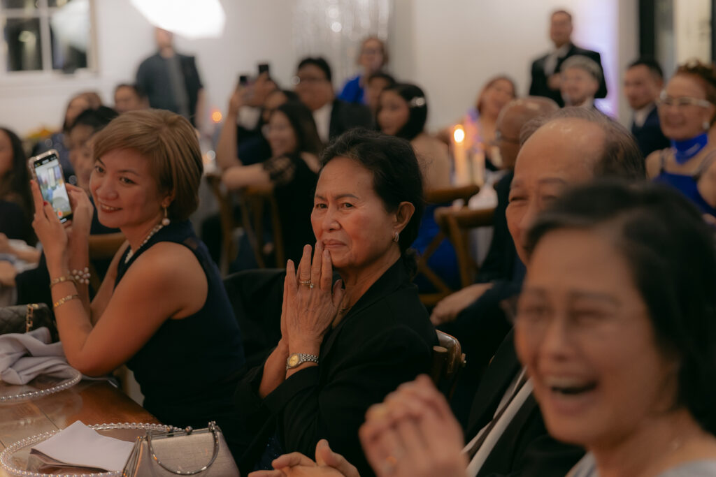 A bride and groom have a candid documentary elopement wedding ceremony in Houston, Texas at the Addison Woods Wedding Venue followed by modern classy bridal portraits and candid photos while interacting with their reception guests.