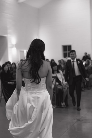 A bride and groom have a candid documentary elopement wedding ceremony in Houston, Texas at the Addison Woods Wedding Venue followed by modern classy bridal portraits and candid photos while interacting with their reception guests.