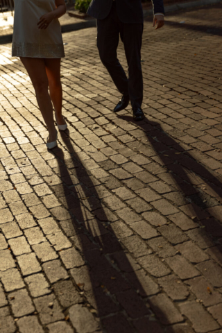 A couple in editorial neutral attire take their documentary and cinematic style wedding engagement photos in Downtown Fort Worth.