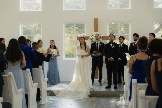 A bride and groom have a candid documentary elopement wedding ceremony in Houston, Texas at the Addison Woods Wedding Venue followed by modern classy bridal portraits and candid photos while interacting with their reception guests.