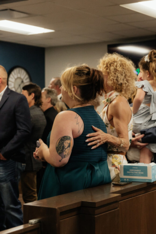 A bride and groom have a candid documentary elopement wedding ceremony in Dallas, Texas, followed by modern classy bridal portraits and candid photos while interacting with their reception guests.