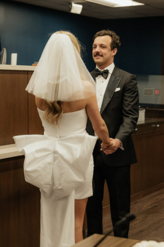 A bride and groom have a candid documentary elopement wedding ceremony in Dallas, Texas, followed by modern classy bridal portraits and candid photos while interacting with their reception guests.