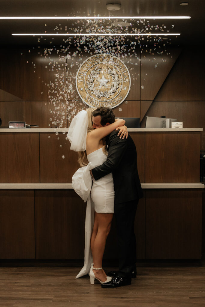 A bride and groom have a candid documentary elopement wedding ceremony in Dallas, Texas, followed by modern classy bridal portraits and candid photos while interacting with their reception guests.