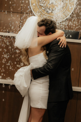 A bride and groom have a candid documentary elopement wedding ceremony in Dallas, Texas, followed by modern classy bridal portraits and candid photos while interacting with their reception guests.