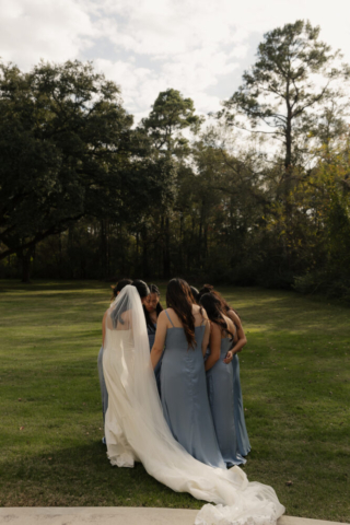 A bride and groom have a candid documentary elopement wedding ceremony in Houston, Texas at the Addison Woods Wedding Venue followed by modern classy bridal portraits and candid photos while interacting with their reception guests.