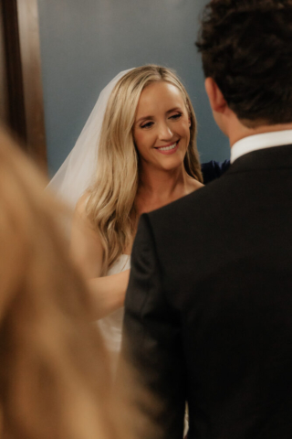 A bride and groom have a candid documentary elopement wedding ceremony in Dallas, Texas, followed by modern classy bridal portraits and candid photos while interacting with their reception guests.