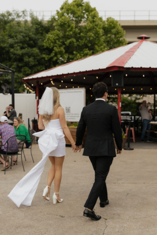 A bride and groom have a candid documentary elopement wedding ceremony in Dallas, Texas, followed by modern classy bridal portraits and candid photos while interacting with their reception guests.