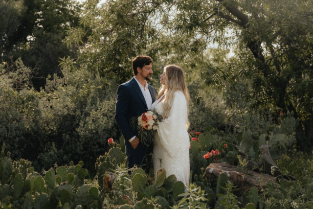 A young bride and groom at the Tarrant County Courthouse and Fort Worth Stockyards on their intimate elopement wedding day in Fort Worth, Texas.