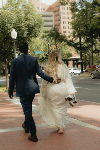 A young bride and groom at the Tarrant County Courthouse and Fort Worth Stockyards on their intimate elopement wedding day in Fort Worth, Texas.