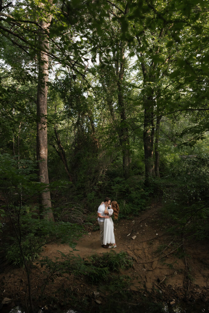 Romantic engagement photos at the Grapevine Botanical Garden, capturing a couple&rsquo;s love amidst lush greenery and vibrant blooms. Perfect for couples seeking a serene, nature-inspired setting for their engagement session in DFW.