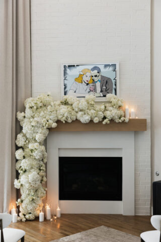 White flowers line a modern fire place. Timeless indoor wedding in Dallas, captured with a refined, editorial approach.