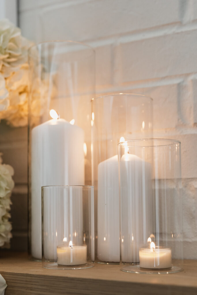 Simple, white flowers line the base of a white flower arch in a modern white aesthetic home for a wedding ceremony. Timeless indoor wedding in Dallas, captured with a refined, editorial approach by DFW documentary wedding photographer.
