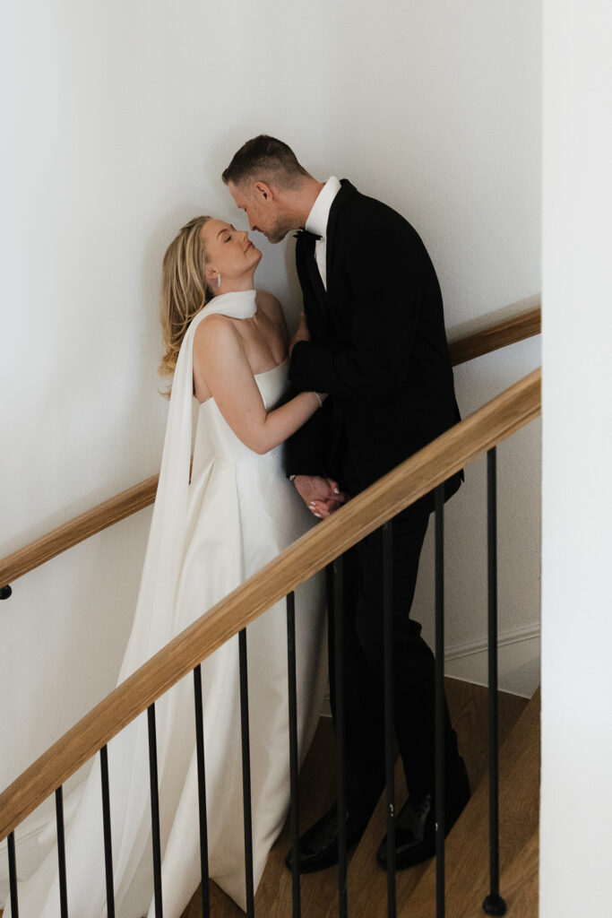 A bride and groom, take couples portraits in their modern aesthetic home at their private wedding ceremony.Timeless indoor wedding in Dallas, captured with a refined, editorial approach by DFW documentary wedding photographer.