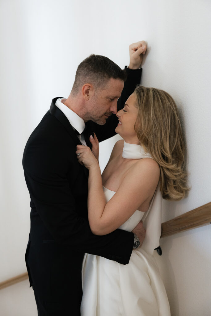 A bride and groom, take couples portraits in their modern aesthetic home at their private wedding ceremony.Timeless indoor wedding in Dallas, captured with a refined, editorial approach by DFW documentary wedding photographer.