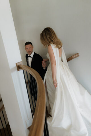 A bride and groom, take couples portraits in their modern aesthetic home at their private wedding ceremony.Timeless indoor wedding in Dallas, captured with a refined, editorial approach by DFW documentary wedding photographer.