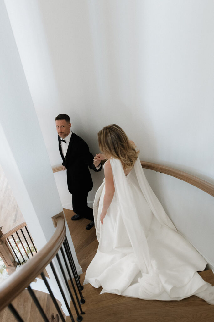 A bride and groom, take couples portraits in their modern aesthetic home at their private wedding ceremony.Timeless indoor wedding in Dallas, captured with a refined, editorial approach by DFW documentary wedding photographer.