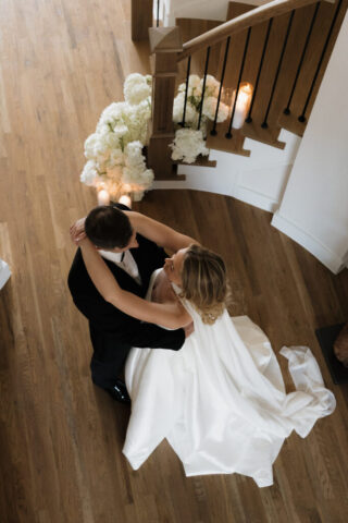 A bride and groom, take couples portraits in their modern aesthetic home at their private wedding ceremony.Timeless indoor wedding in Dallas, captured with a refined, editorial approach by DFW documentary wedding photographer.