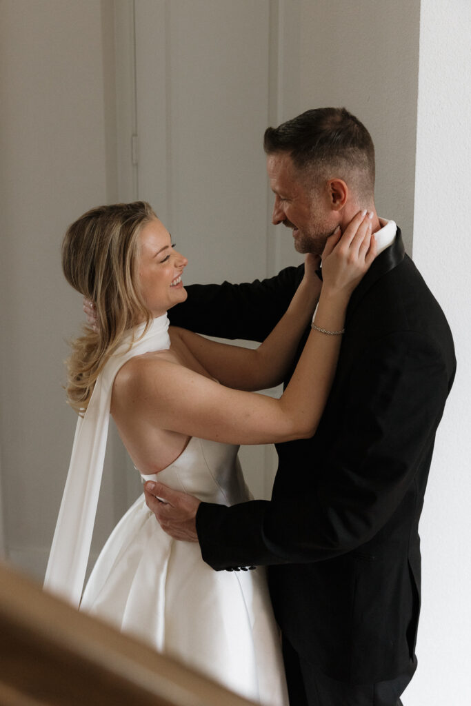 A bride and groom, take couples portraits in their modern aesthetic home at their private wedding ceremony.Timeless indoor wedding in Dallas, captured with a refined, editorial approach by DFW documentary wedding photographer.