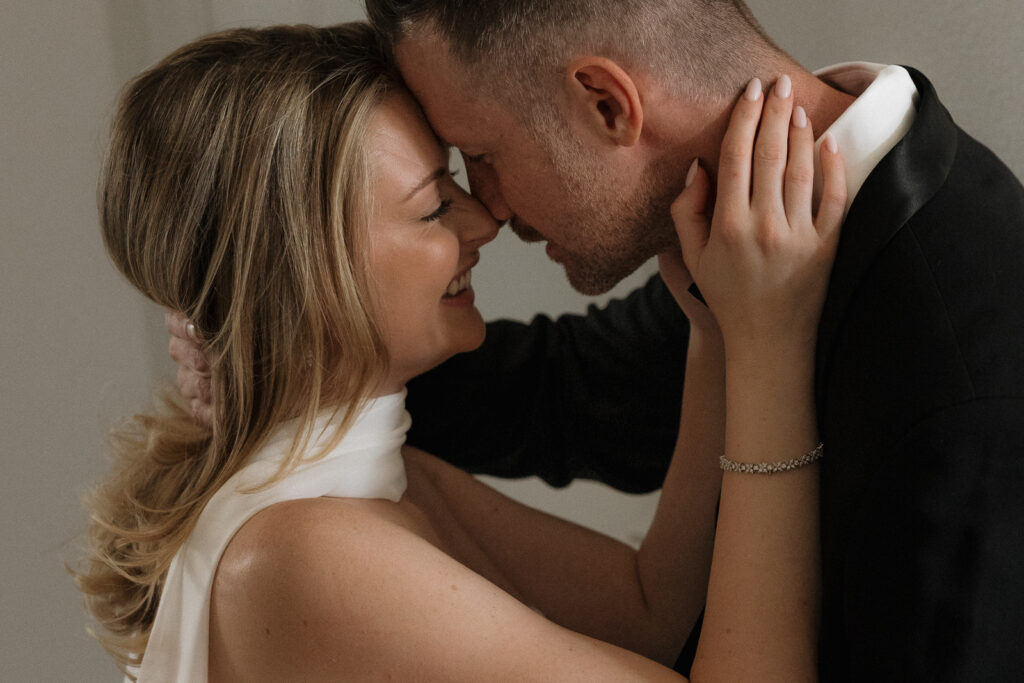 A bride and groom, take couples portraits in their modern aesthetic home at their private wedding ceremony.Timeless indoor wedding in Dallas, captured with a refined, editorial approach by DFW documentary wedding photographer.