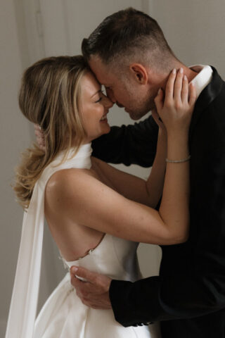 A bride and groom, take couples portraits in their modern aesthetic home at their private wedding ceremony.Timeless indoor wedding in Dallas, captured with a refined, editorial approach by DFW documentary wedding photographer.