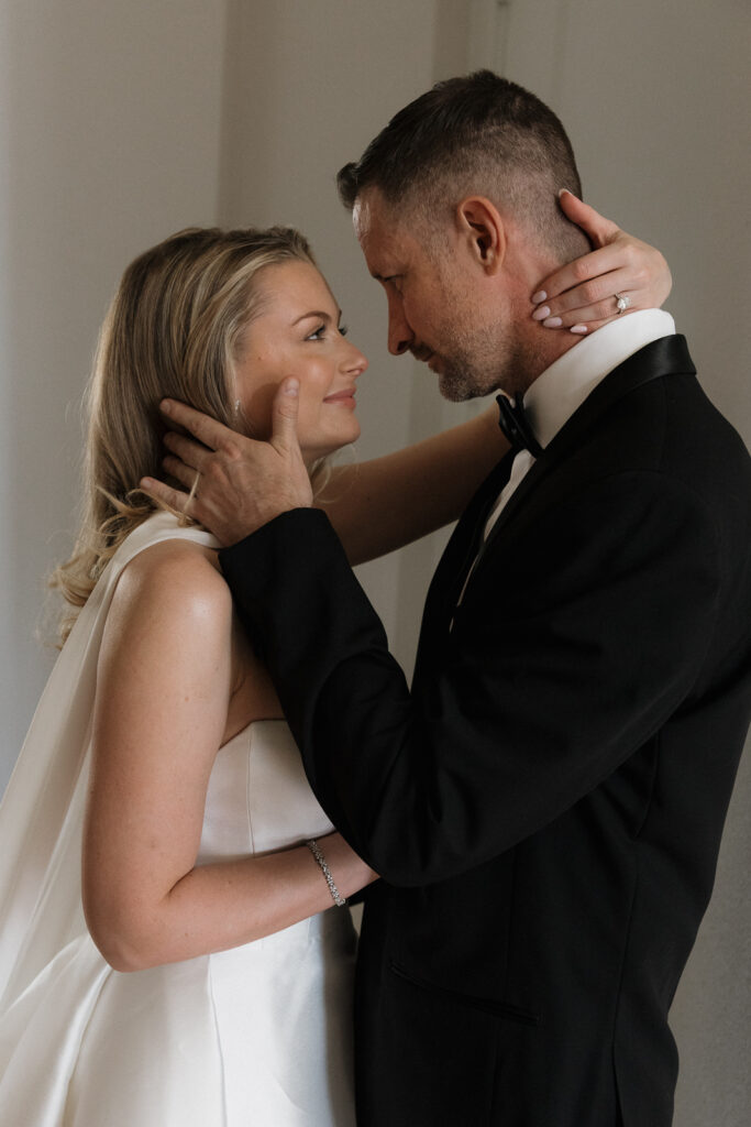A bride and groom, take couples portraits in their modern aesthetic home at their private wedding ceremony.Timeless indoor wedding in Dallas, captured with a refined, editorial approach by DFW documentary wedding photographer.