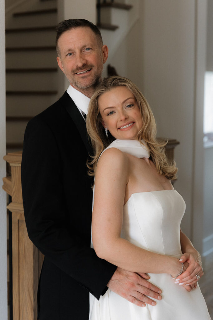 A bride and groom, take couples portraits in their modern aesthetic home at their private wedding ceremony.Timeless indoor wedding in Dallas, captured with a refined, editorial approach by DFW documentary wedding photographer.
