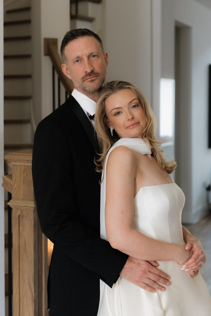 A bride and groom, take couples portraits in their modern aesthetic home at their private wedding ceremony.Timeless indoor wedding in Dallas, captured with a refined, editorial approach by DFW documentary wedding photographer.