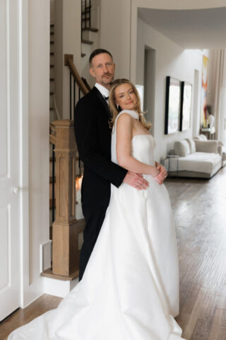 A bride and groom, take couples portraits in their modern aesthetic home at their private wedding ceremony.Timeless indoor wedding in Dallas, captured with a refined, editorial approach by DFW documentary wedding photographer.
