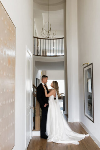 A bride and groom, take couples portraits in their modern aesthetic home at their private wedding ceremony.Timeless indoor wedding in Dallas, captured with a refined, editorial approach by DFW documentary wedding photographer.