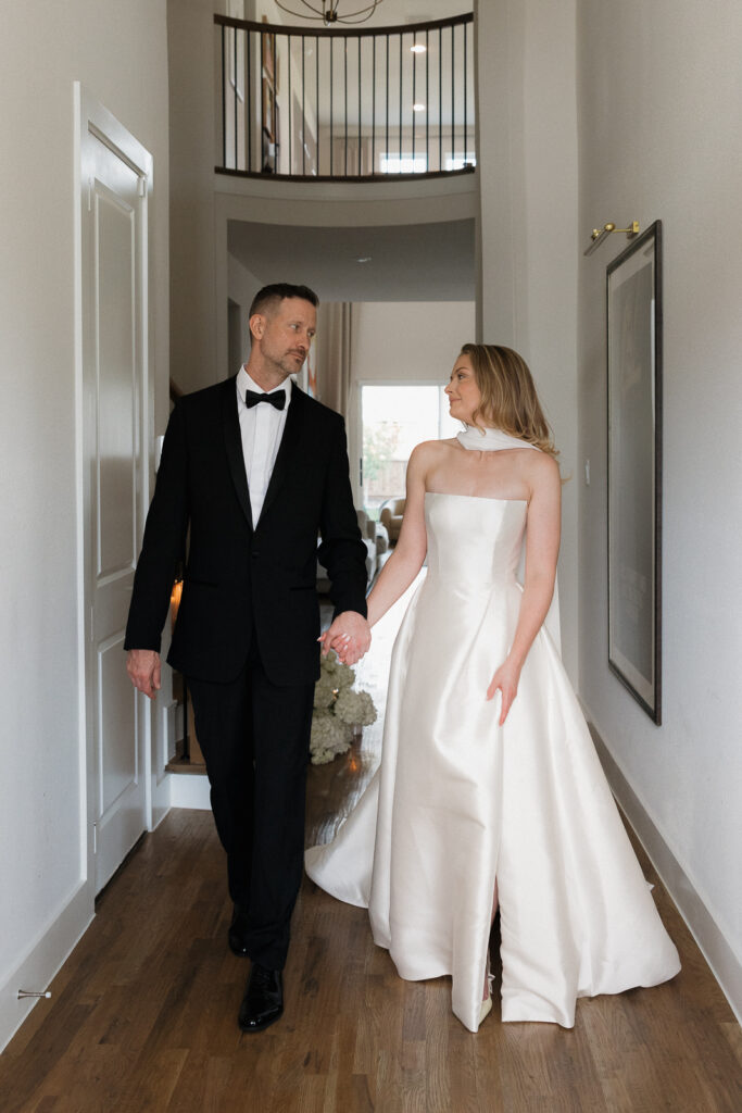 A bride and groom, take couples portraits in their modern aesthetic home at their private wedding ceremony.Timeless indoor wedding in Dallas, captured with a refined, editorial approach by DFW documentary wedding photographer.
