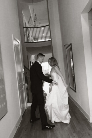 A bride and groom, take couples portraits in their modern aesthetic home at their private wedding ceremony.Timeless indoor wedding in Dallas, captured with a refined, editorial approach by DFW documentary wedding photographer.