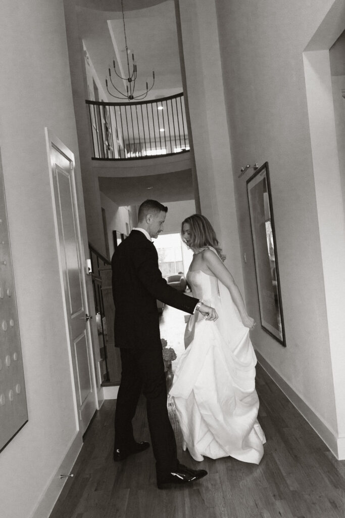 A bride and groom, take couples portraits in their modern aesthetic home at their private wedding ceremony.Timeless indoor wedding in Dallas, captured with a refined, editorial approach by DFW documentary wedding photographer.