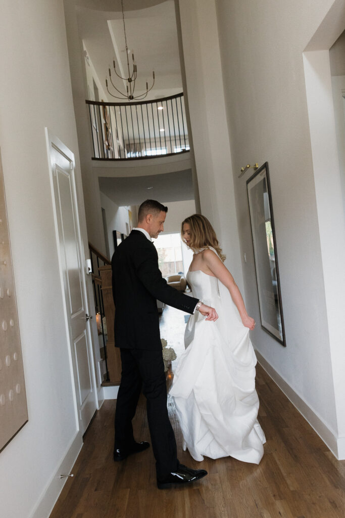 A bride and groom, take couples portraits in their modern aesthetic home at their private wedding ceremony.Timeless indoor wedding in Dallas, captured with a refined, editorial approach by DFW documentary wedding photographer.
