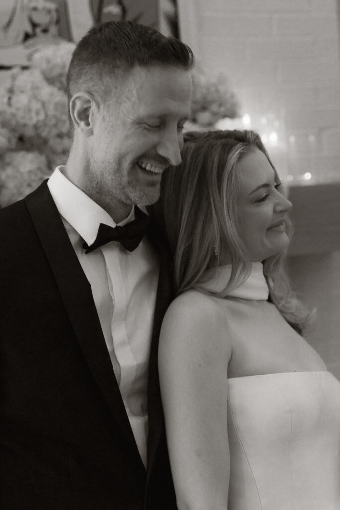 A bride and groom, take couples portraits in their modern aesthetic home at their private wedding ceremony.Timeless indoor wedding in Dallas, captured with a refined, editorial approach by DFW documentary wedding photographer.