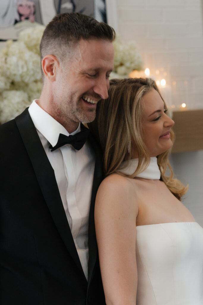 A bride and groom, take couples portraits in their modern aesthetic home at their private wedding ceremony.Timeless indoor wedding in Dallas, captured with a refined, editorial approach by DFW documentary wedding photographer.