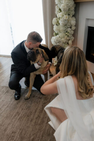 A bride and groom take photos with their pet dog in their modern aesthetic home at their private wedding ceremony.Timeless indoor wedding in Dallas, captured with a refined, editorial approach by DFW documentary wedding photographer.