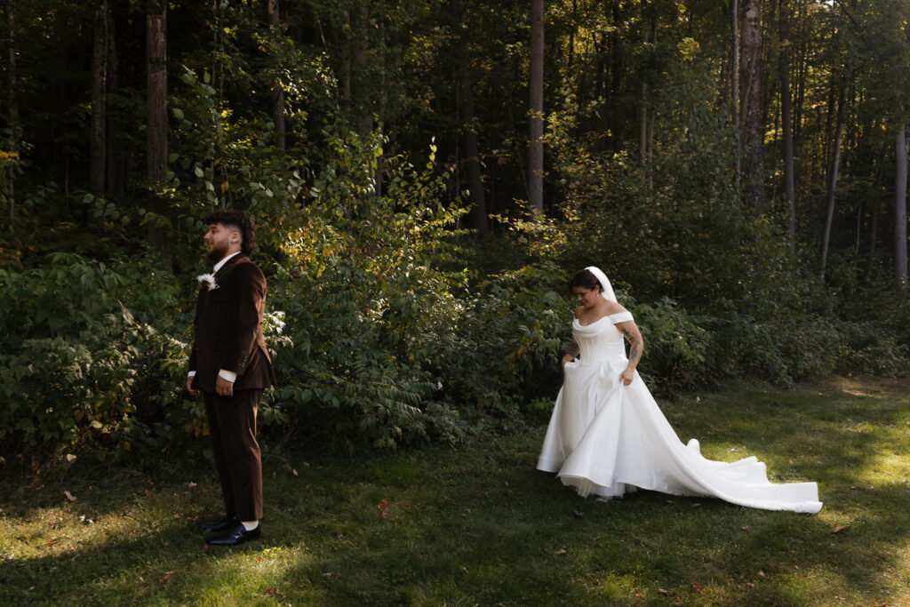 Bride walking towards groom in a forest setting