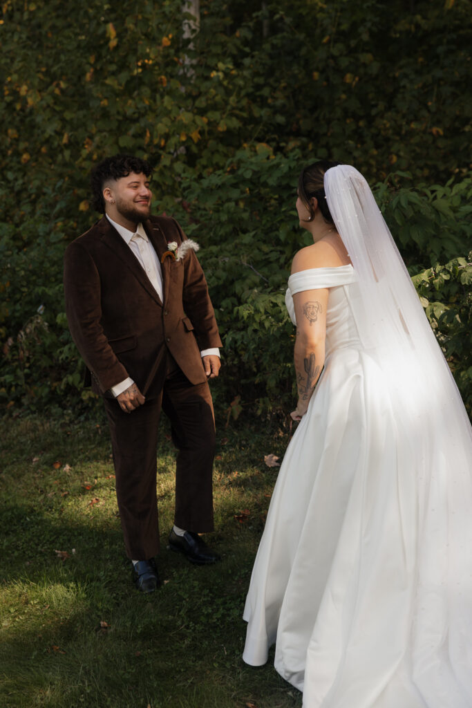 Bride and groom in outdoor setting with greenery background.