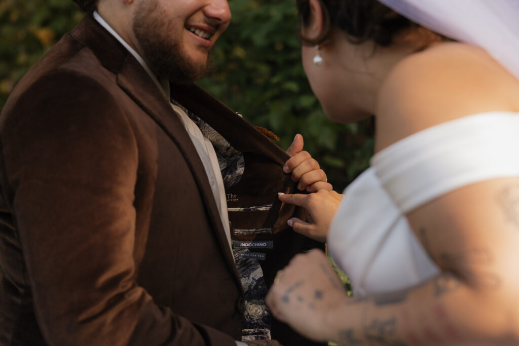 Bride examines groom's jacket lining