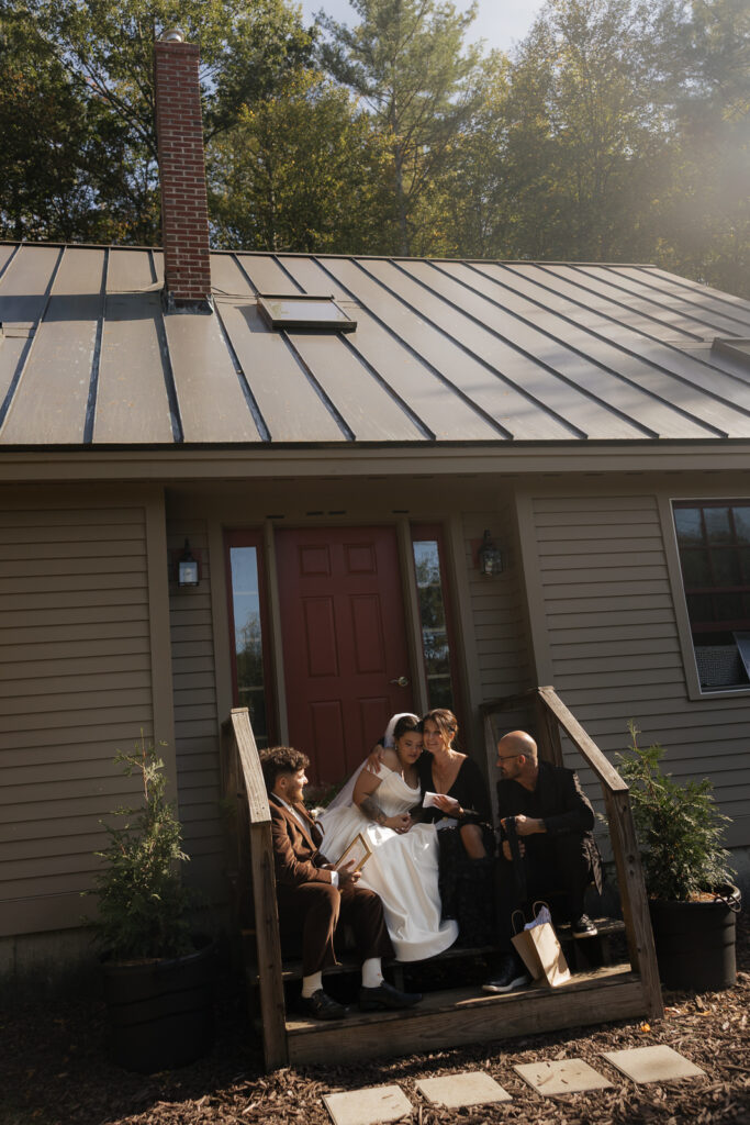 Bride and family sitting on porch steps