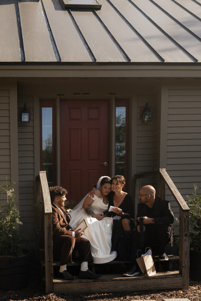 Bride with family on porch reading letter