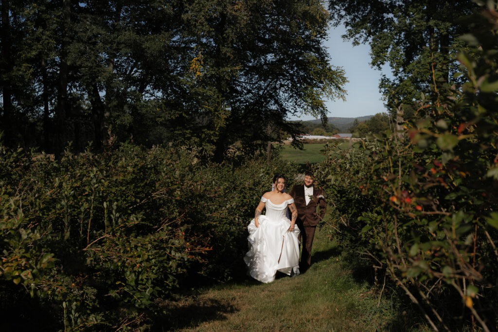 Bride and groom walking through a lush garden