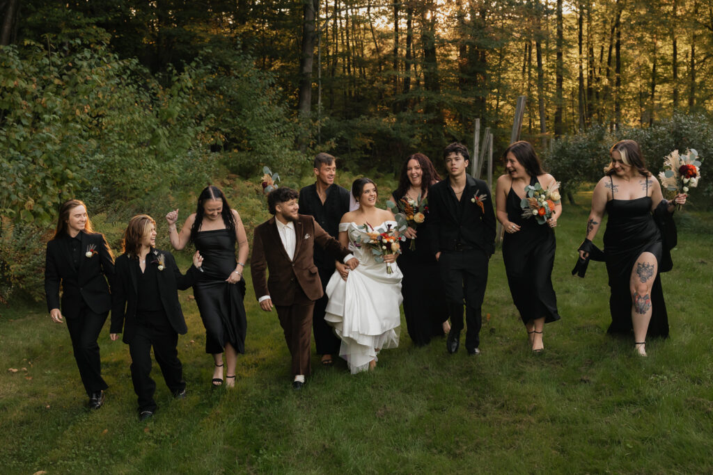 Bride and bridal party walking in outdoor setting