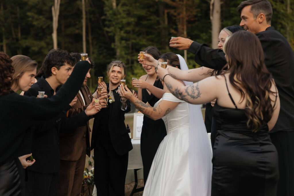 wedding guests raising glasses in a toast