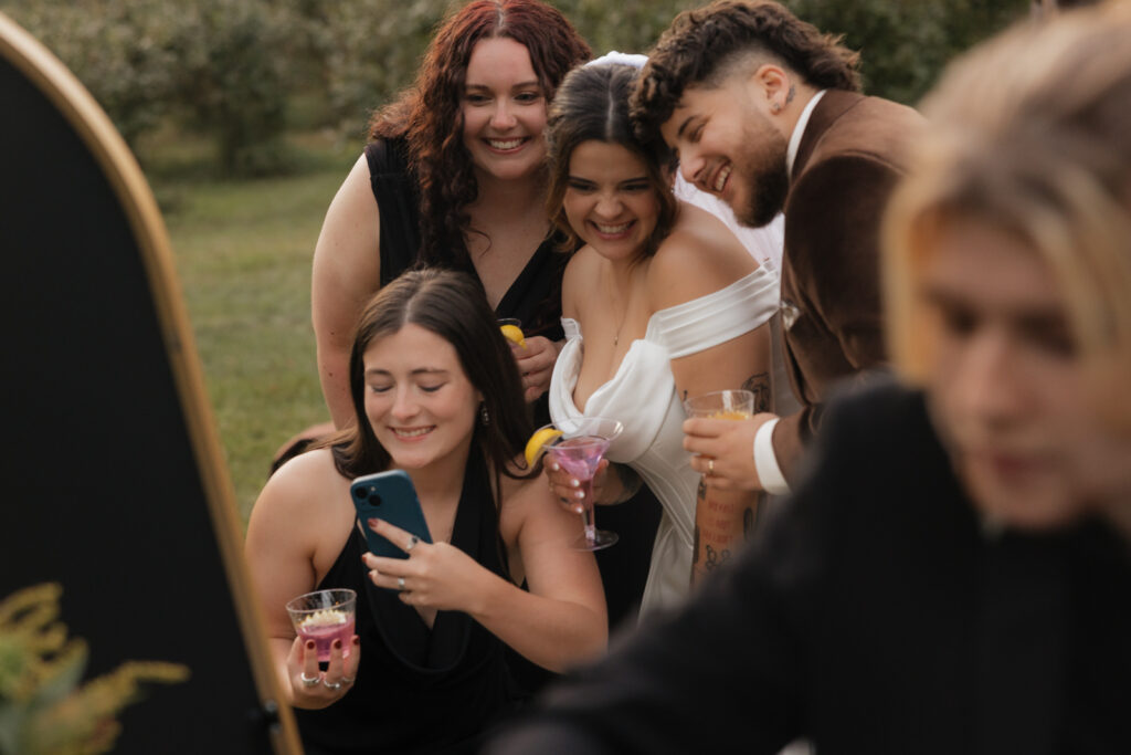 Group of friends taking a selfie at a celebration outdoors